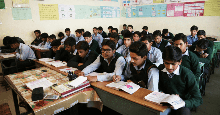 Students sitting quietly in rows in an Indian classroom, illustrating the obedience vs intelligence divide in schooling