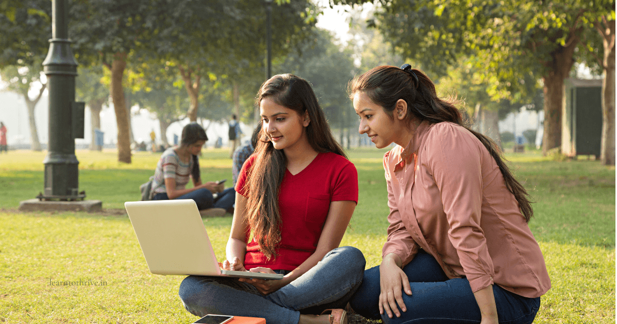 How to choose the right engineering college in India — two Indian college students studying together outdoors